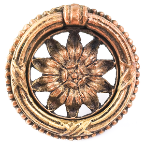 An ornately-decorated vintage brass ring pull with a sunflower design in the middle.