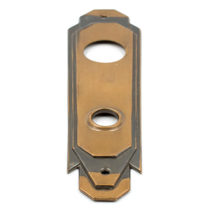 A low-angle photo of a bronze Art Deco escutcheon