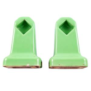 A pair of vintage, bright green wall-mounted towel holder ends with diamond-shaped recesses