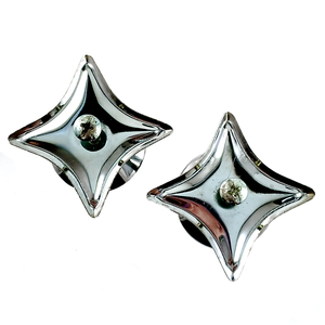 The backs of two chrome-plated back plates in the shapes of four-pointed stars, with screws in the middle of each plate and knobs slightly visible behind the plates