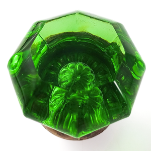 An angled head-on view, showing the flower shape again and the gemmy green glass