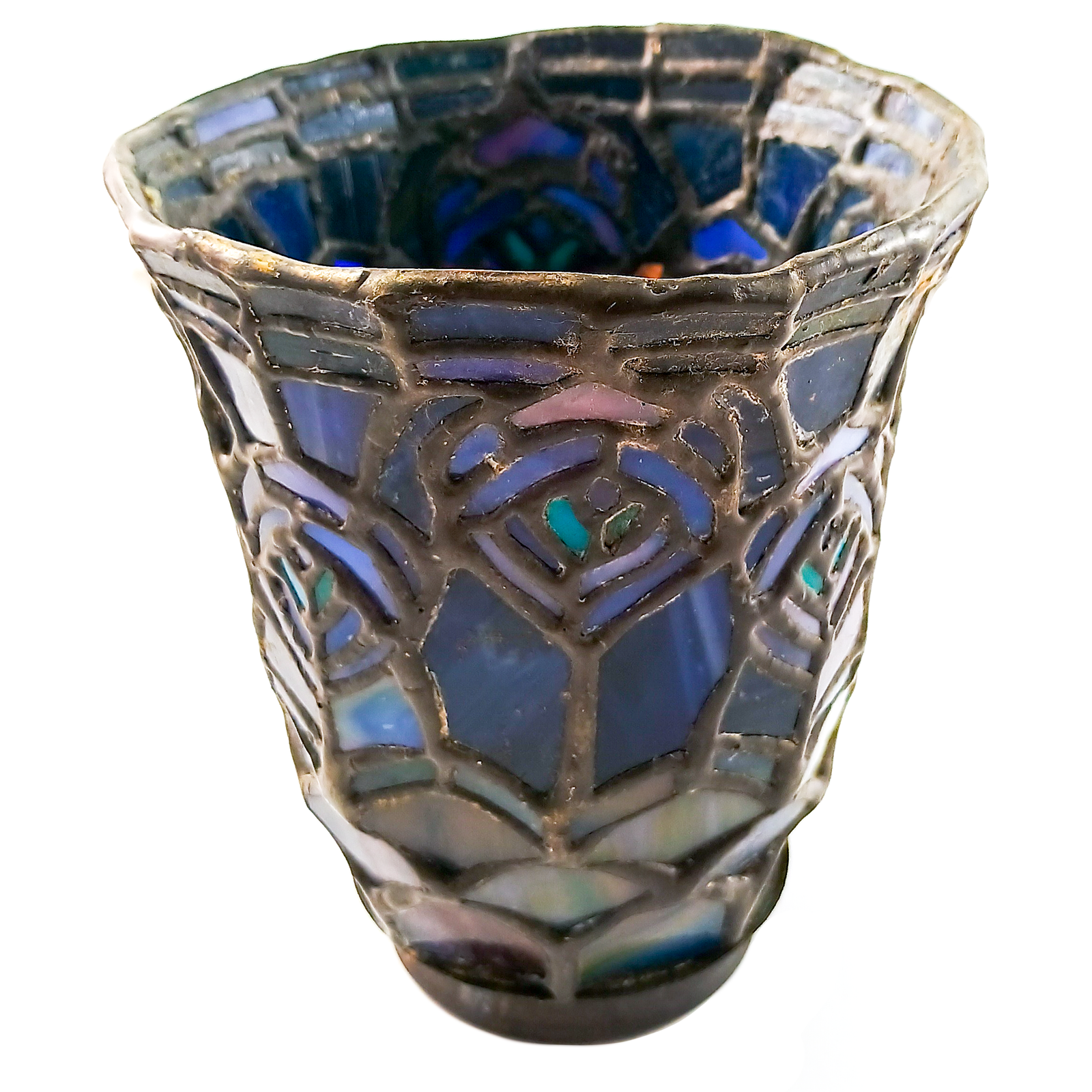 A stained glass lamp shade pointed downward, with a pattern resembling peacock feathers in shades of blue, aqua, and pink, with a scaled pattern at the base which appears green, blue, and purple, and a dark bronze finished fitter