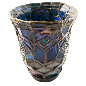 A stained glass bell-shaped lamp shade stood upright, with a pattern resembling peacock feathers in shades of blue, aqua, and pink, with glass at the base that appears green and purple, and a dark bronze finished fitter
