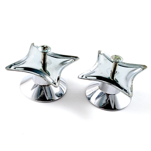 Two chrome-plated knobs with four-pointed star-shaped back plates and screws sticking out, photographed from behind at an angle