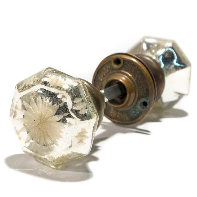 A set of antique mercury glass doorknobs with floral bronze rosettes