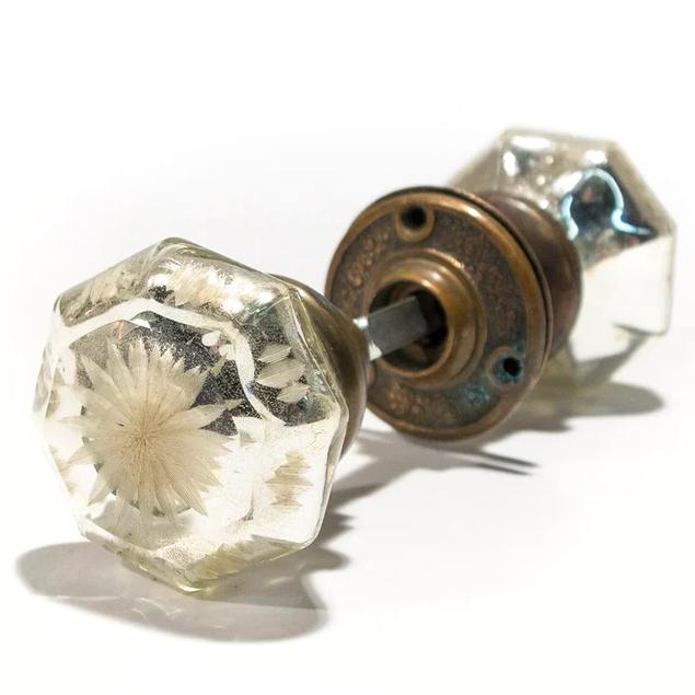 A set of antique mercury glass doorknobs with floral bronze rosettes