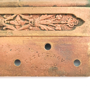 A close-up of one patent stamp, reading "PATENT. NO 2. 1869." There is also a more faded stamp reading 5 x 5