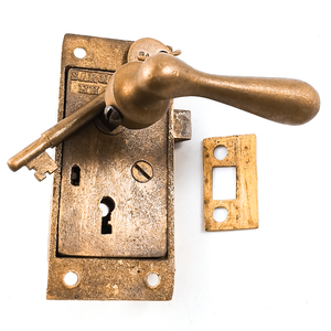 A Sargent locking latch set with a small brass strike plate