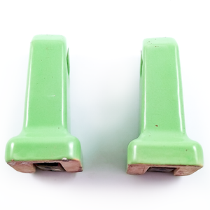 The sides of the towel holder ends, showing some flecks of paint and light crazing