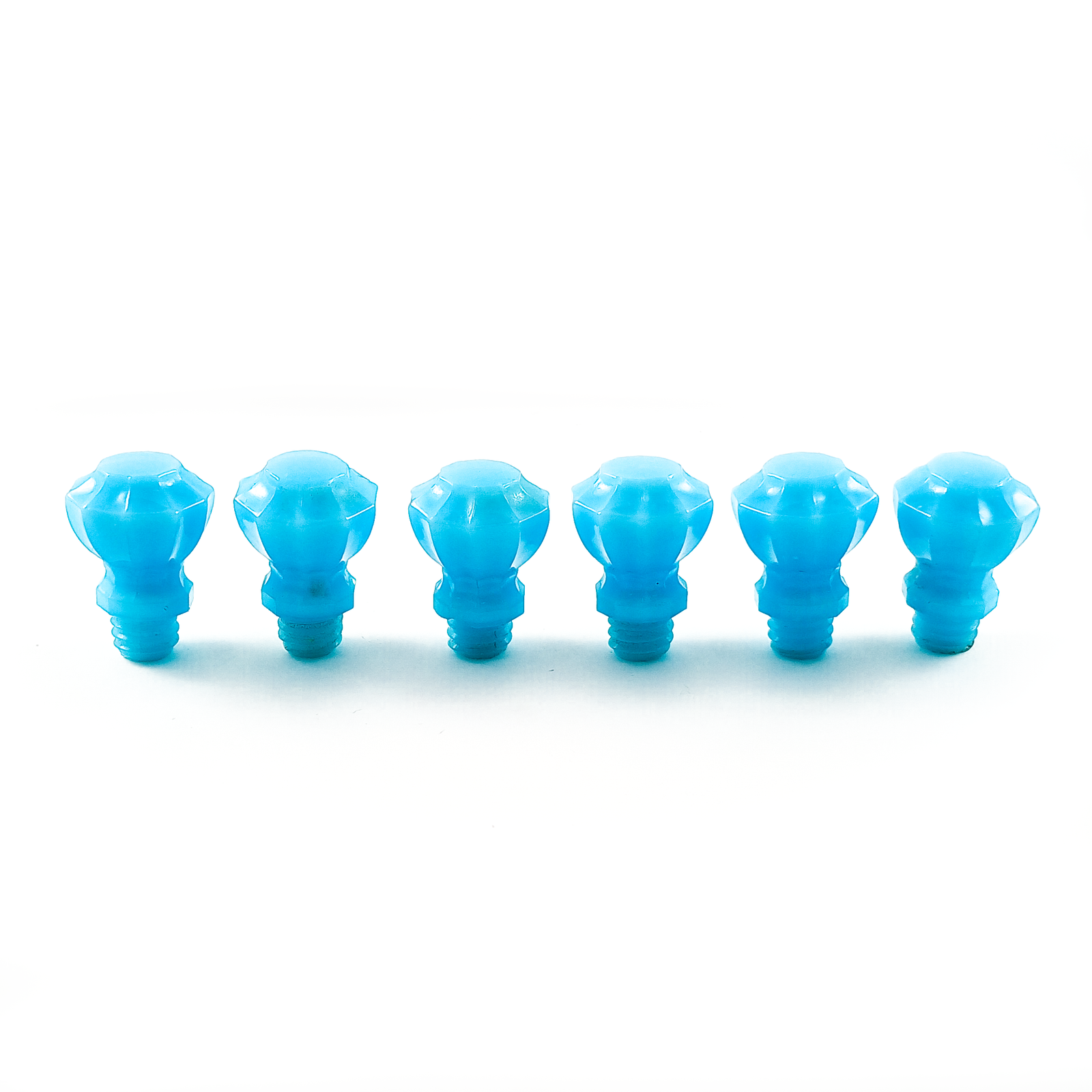 Six fluted light blue glass knobs arranged in a circle, with screw-threaded bases pointing towards the middle