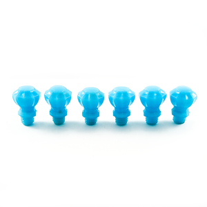 A side view of the six knobs, standing on their bases, showing the fluting on the tops of the knobs