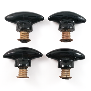 A side view of the same pulls, arranged in a square. They have visible mold press lines, and brass cleats threaded onto the shanks at the base of each pull.