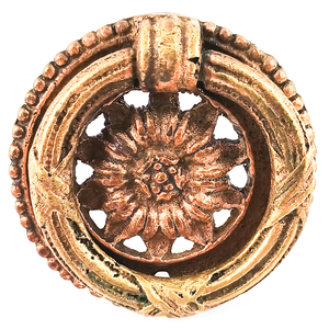 An ornately-decorated vintage brass ring pull with a sunflower design in the middle.