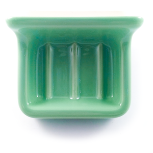 The soap dish, which is a rounded rectangular dish with three pronounced ridges in the bottom