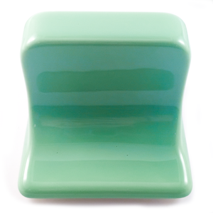 A close-up of the underside of the soap dish, with is smooth glazed green porcelain
