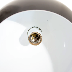 A close-up of the socket of a black pendant lamp with a white interior