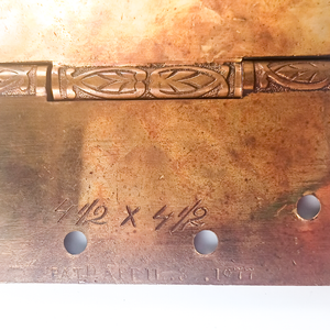 A close-up of one size and patent stamp