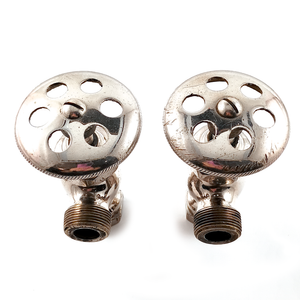 Two nickel-plated angle stops seen from above, showing the large, disc-shaped knobs with six decorative holes in each