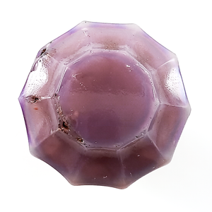 A top-down view of the same knob, showing it has ten facets on the top, as well as a fairly large central table. It also has some bubbles that came to the surface and popped when it was created, which are dark with rust and dirt from decades of storage