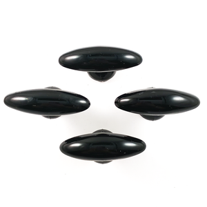 Four black glass oval drawer pulls with round bases, arranged into a diamond shape and viewed head-on