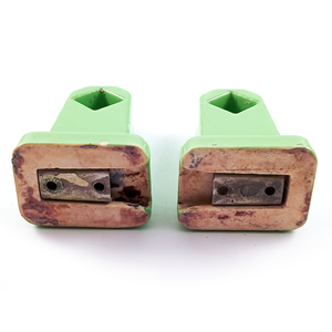 The backs of the towel holder ends, showing the unglazed surface has some wear and staining, as do the included brackets