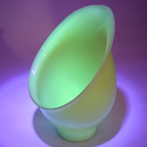 The shade under UV light, making the background appear purple and causing the shade to fluoresce bright green