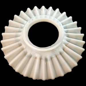 A round, ruffled lamp shade with a large opening, made of white opalescent glass and photographed on a black background