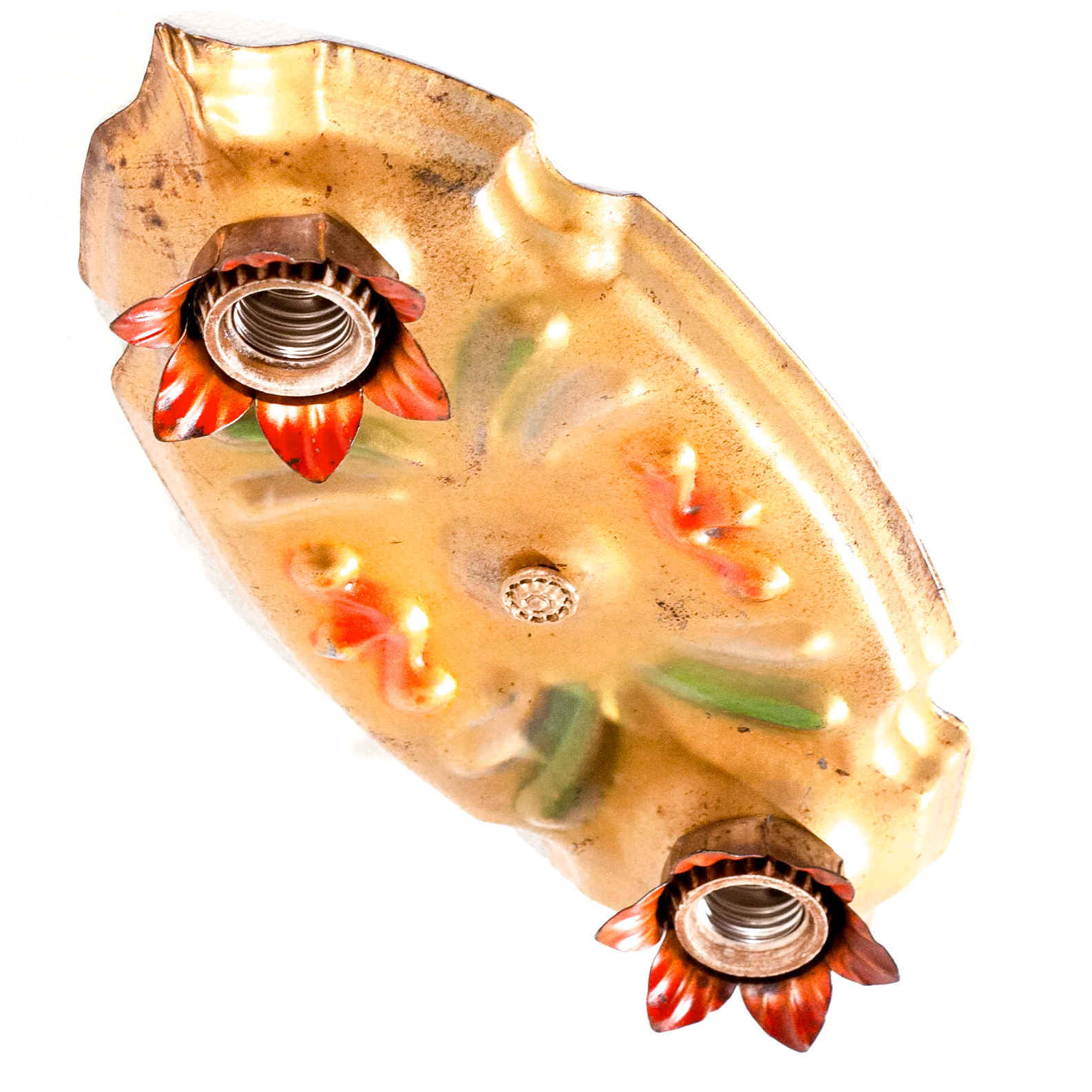 A photo of a vintage gold-tone ceiling light fixture with two sockets, each of which is housed in a red flower shape. There are red and green scrolling decorations in the middle of the fixture.