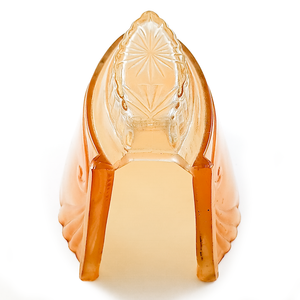 An orange and clear slip shade with a starburst design, showing the hand-ground fitting at the base of the shade and the warm amber light shining through the glass of the shade