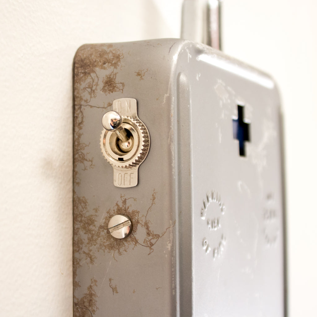 this picture shows the switch and some wear on the base of a schoolhouse electric wall sconce