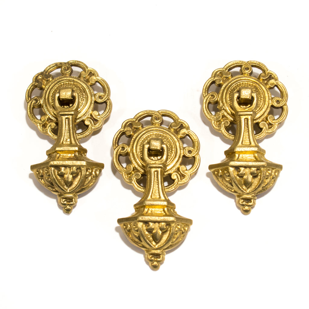 this is a set of 3 antique colonial drop pulls, they are brass colored