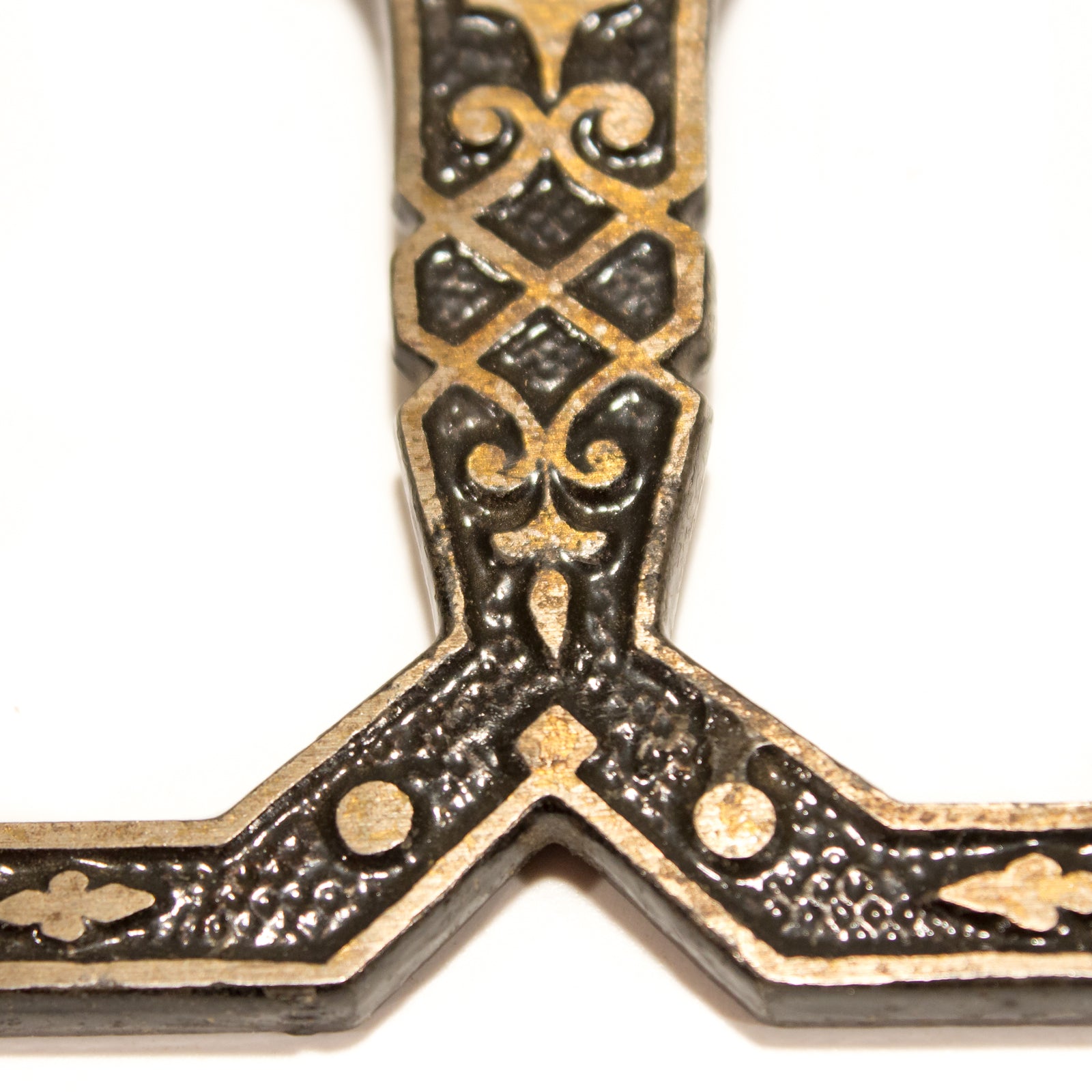 A Victorian ceiling-mounted double hook, decorated in the Eastlake style