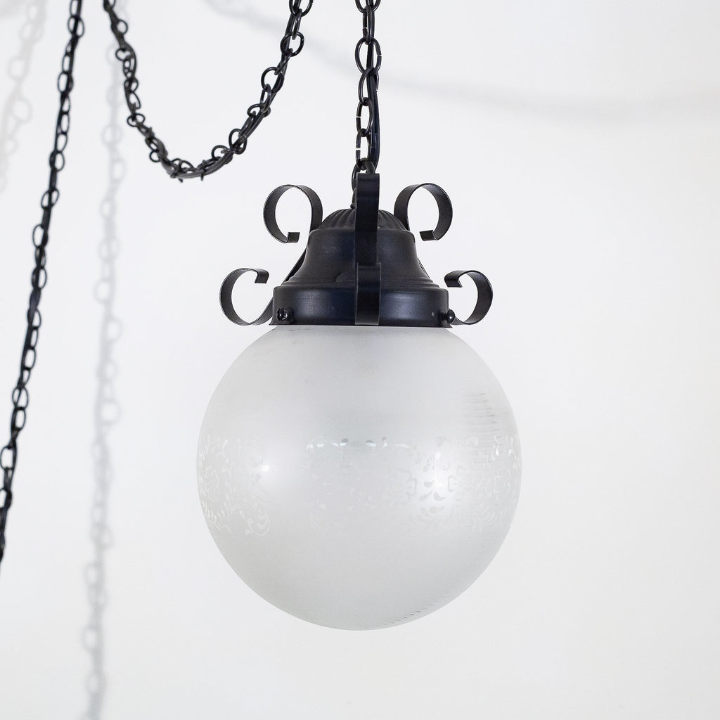 this picture shows a straight view of a vintage frosted glass pendant light fixture