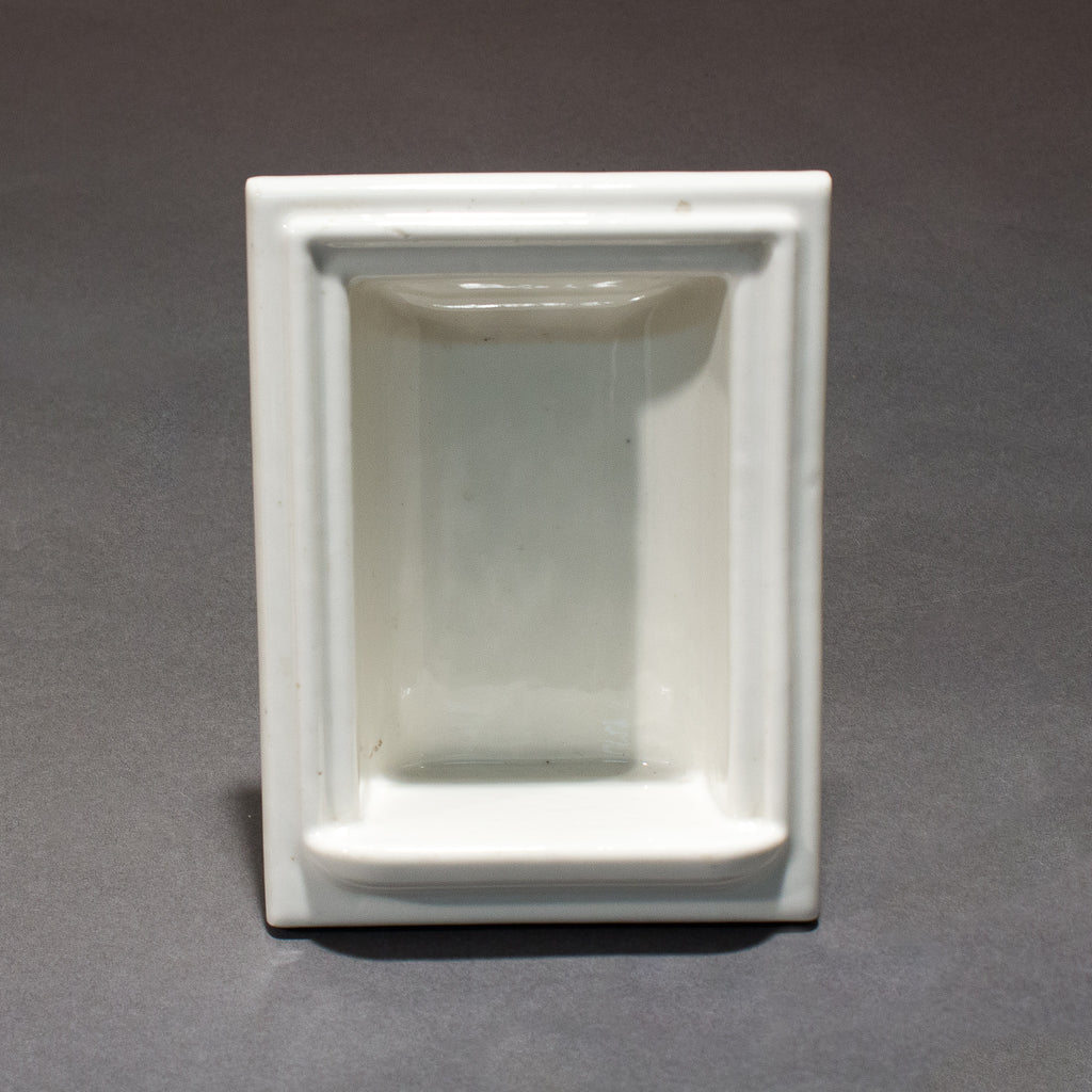 this is the front view of a vintage white porcelain soap holder