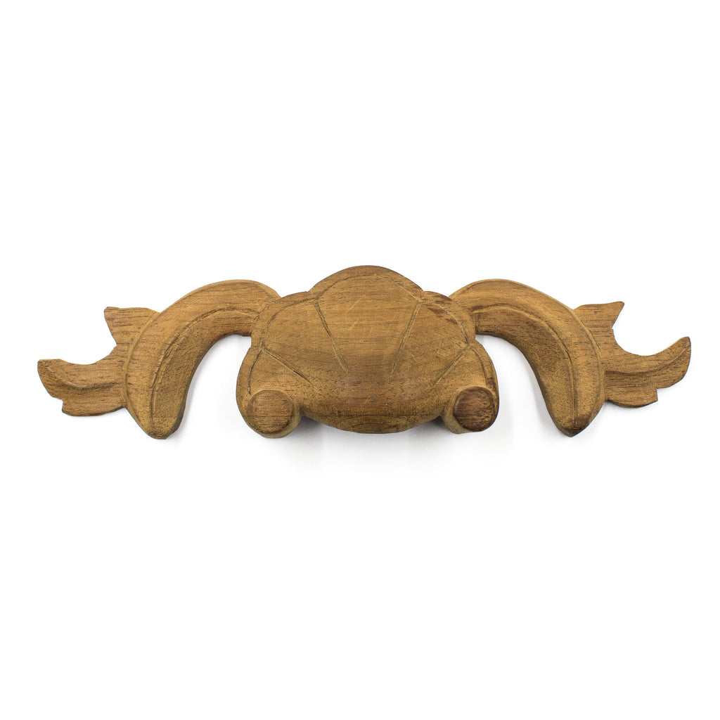 this is an antique carved wood applique pull for a drawer 