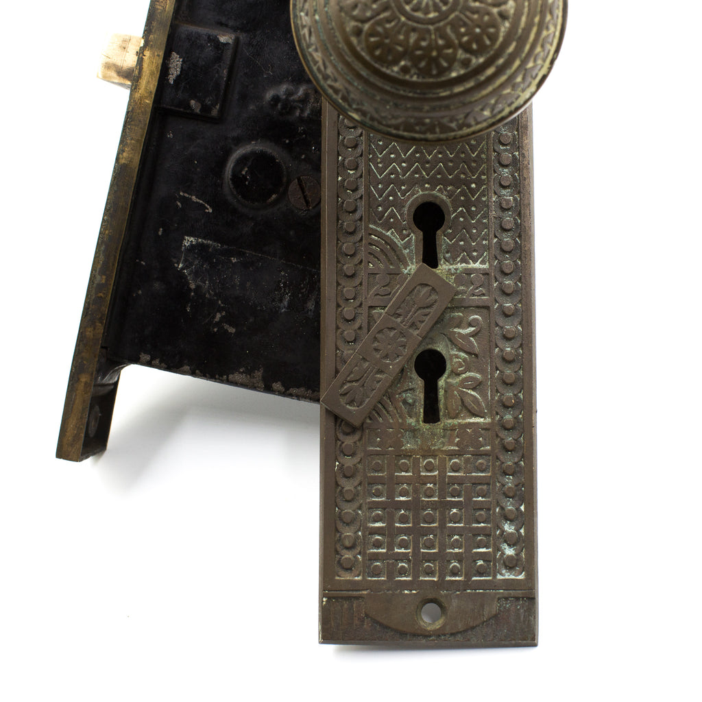 this is a close picture of the bottom half of a vintage Victorian mortise lock set showing the key hole cover on the escutcheon