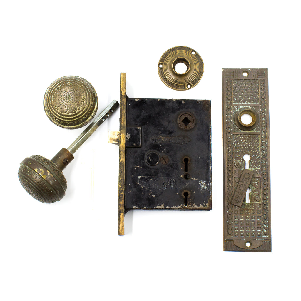 this is a picture of the doorknobs, spindle, rosette, backplate escutcheon, and mortise body on a vintage Victorian mortise lock set