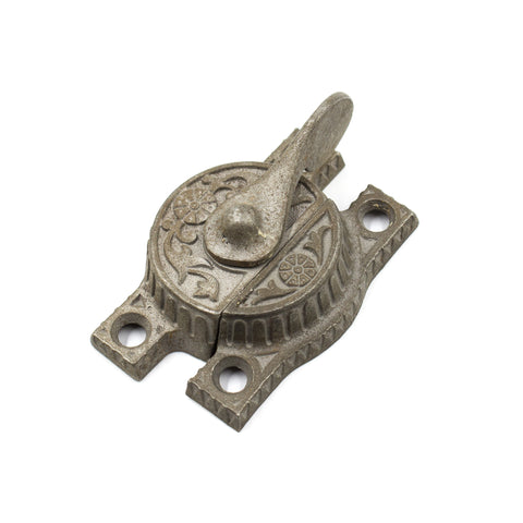 this is an antique victorian sash lock with a floral pattern
