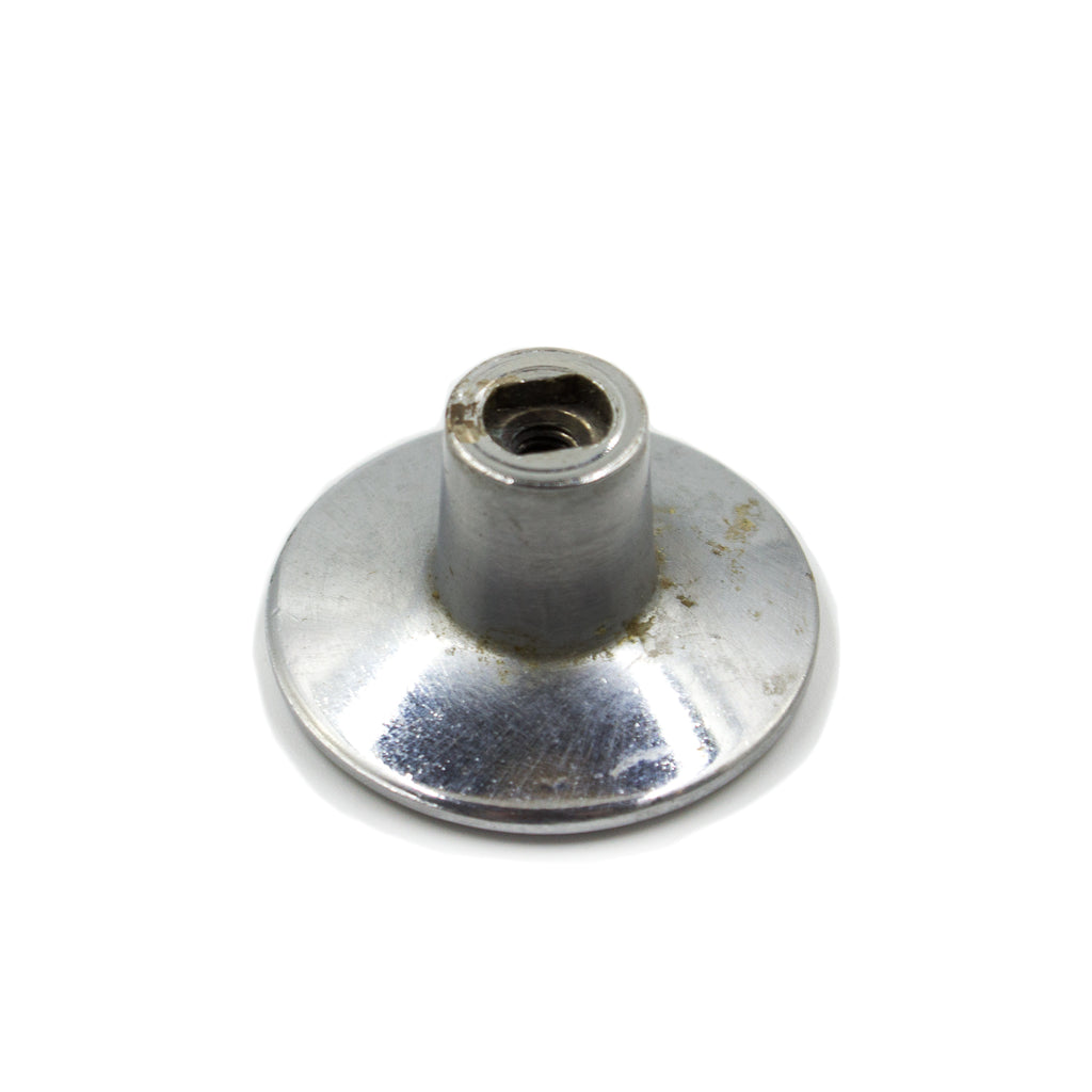 this is the bottom view of a vintage mid century brushed nickel cabinet or drawer pull knob showing where the screw goes