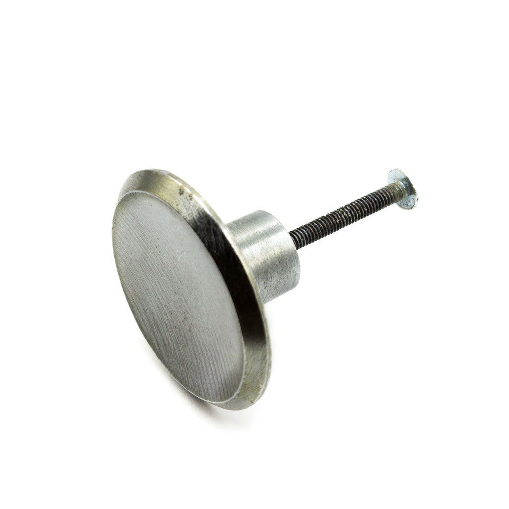 this is a side view of a vintage mid century brushed nickel cabinet or drawer pull knob with the screw in 