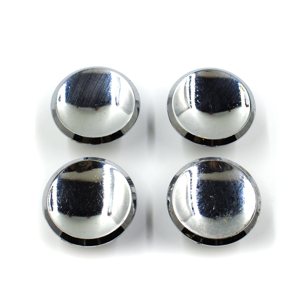 this is a set of four vintage mid century chrome colored cabinet or drawer pull knobs