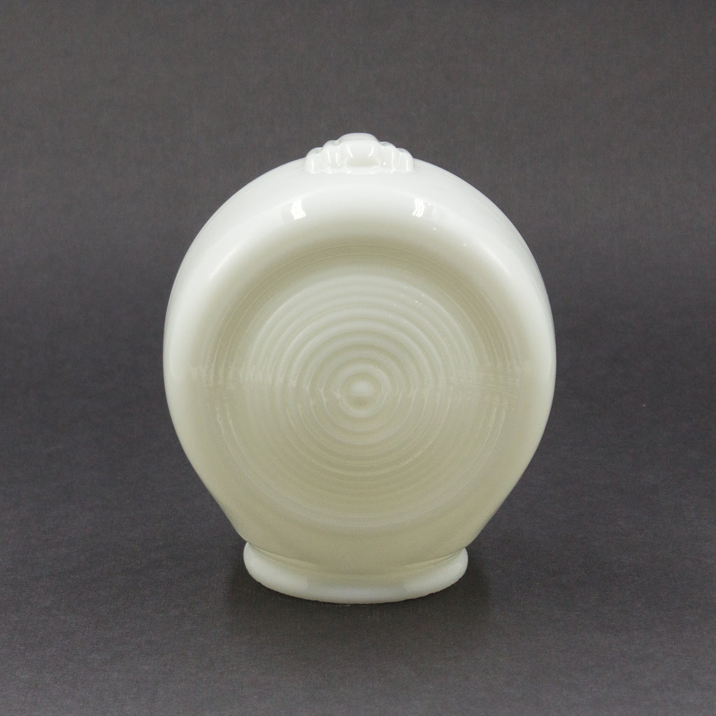 this is the back of a white glass sconce shade showing a ringed pattern