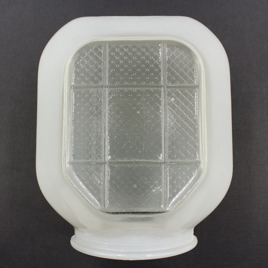 this is a picture of the front of a vintage mid century glass sconce shade showing the clear glass grid and hexagon patterns