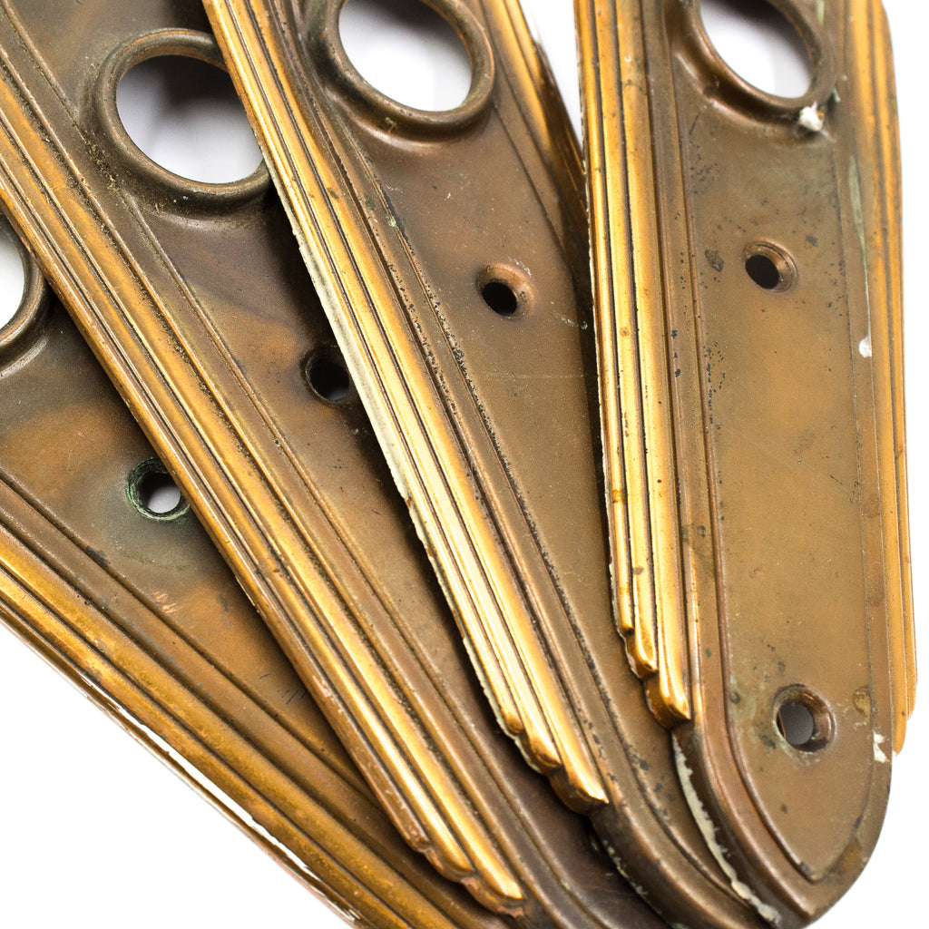 this is a close up picture of the bottom halves of a set of four vintage art deco escutcheons