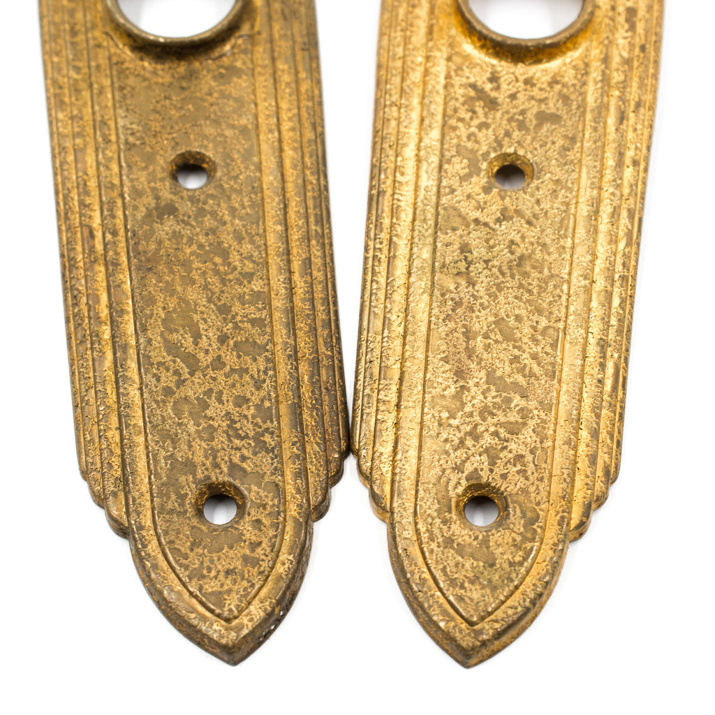 this is a picture of a pair of vintage art deco rose brass escutcheons showing the bottom halves 