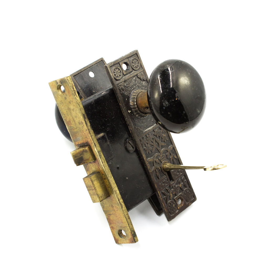 this is an antique vintage victorian door knob set with mortise lock, backplates and key