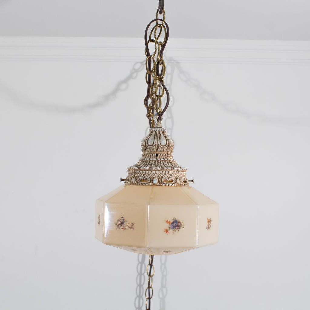 this is a straight on picture of a vintage swag light that shows the decorative canopy, chains, cord and shade