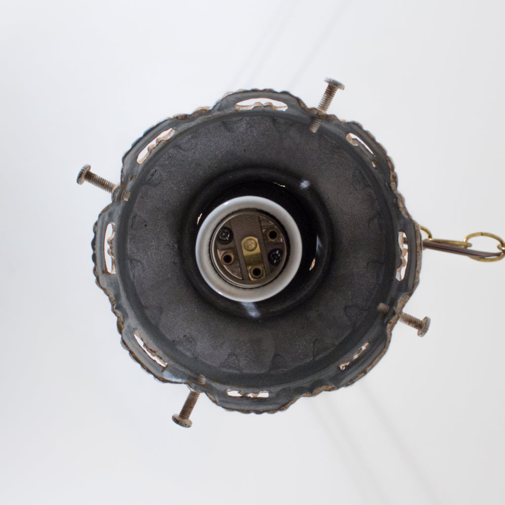 this is a picture of the underside of a canopy and socket on a vintage light fixture
