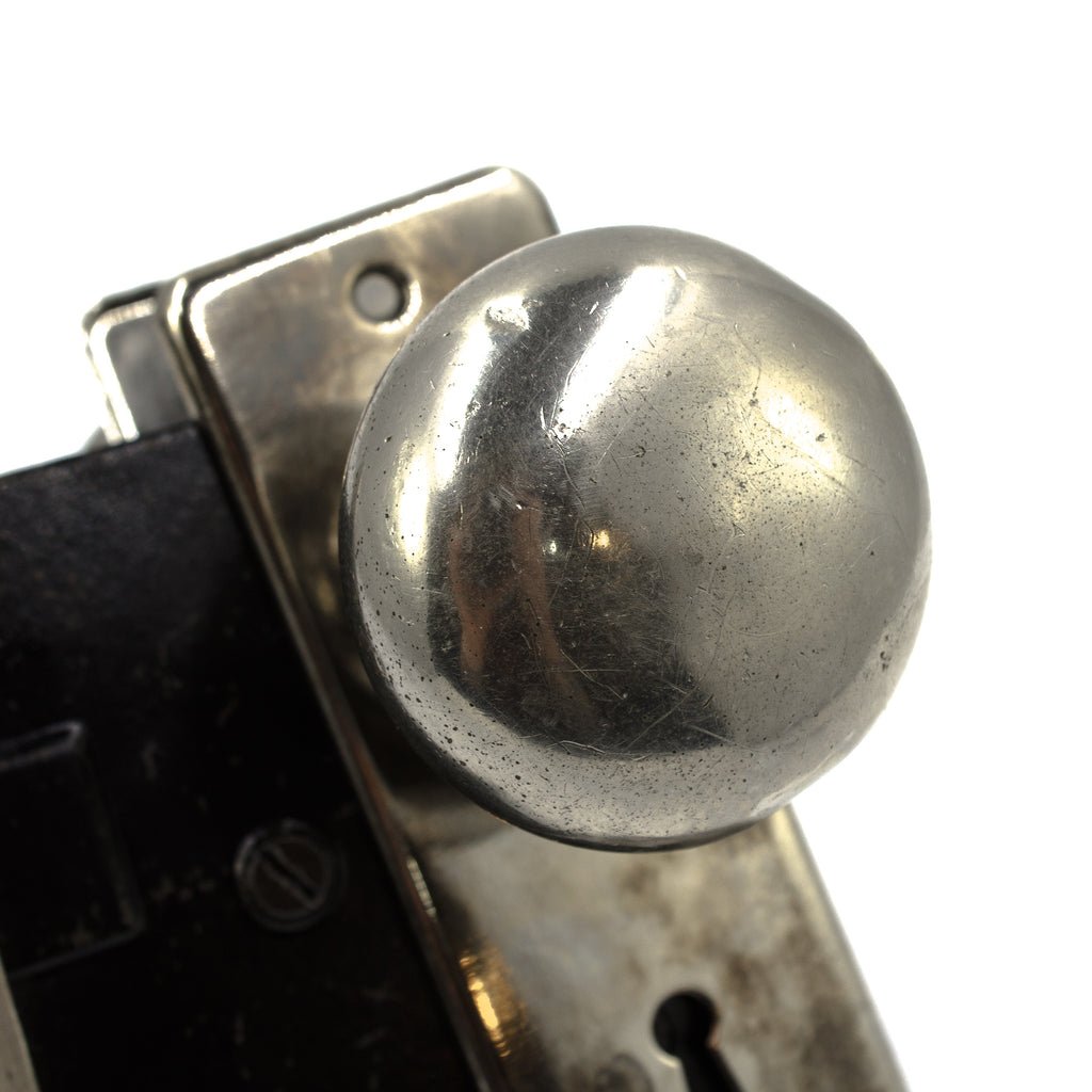 this picture shows the up close detail on a vintage chrome door knob. There are some dings and small scratches