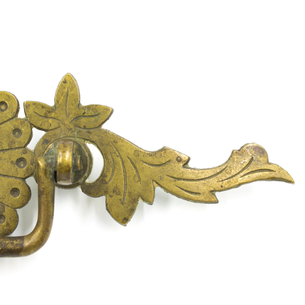 this is a picture of the detail on the side of a vintage brass bail pull